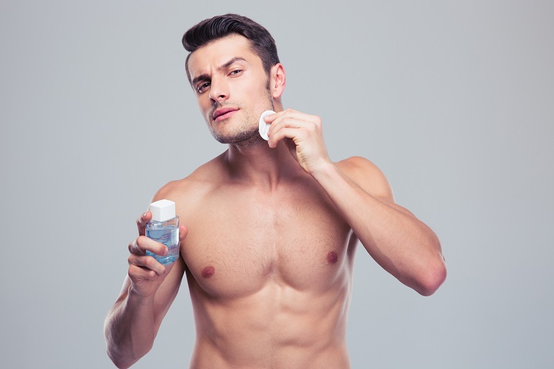 Man applying lotion after shave alcoholic aftershave